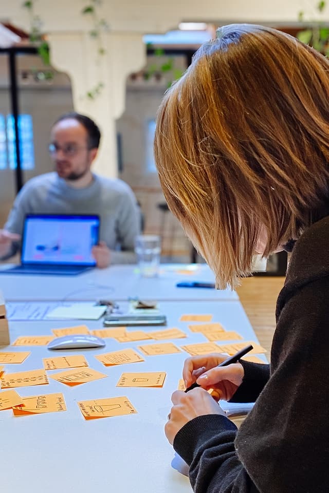 A Radial design sprint in progress, sketching the scoring concept on sticky notes.
